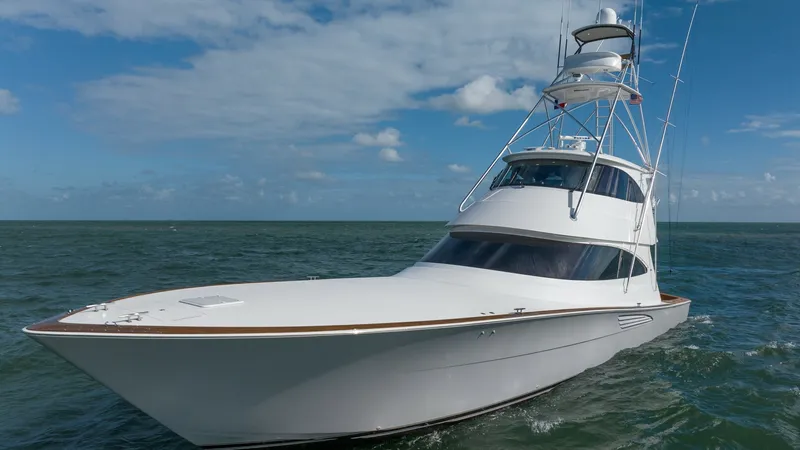 Slide: The Image of Bow and Enclosed Bridge Profile This striking image showcases the sleek bow and sophisticated enclosed bridge of the 2019 Viking 68 Enclosed Bridge. The vessel's aerodynamic design is complemented by its polished white finish, emphasizing its elegance and performance on the open sea. Th - 8738089