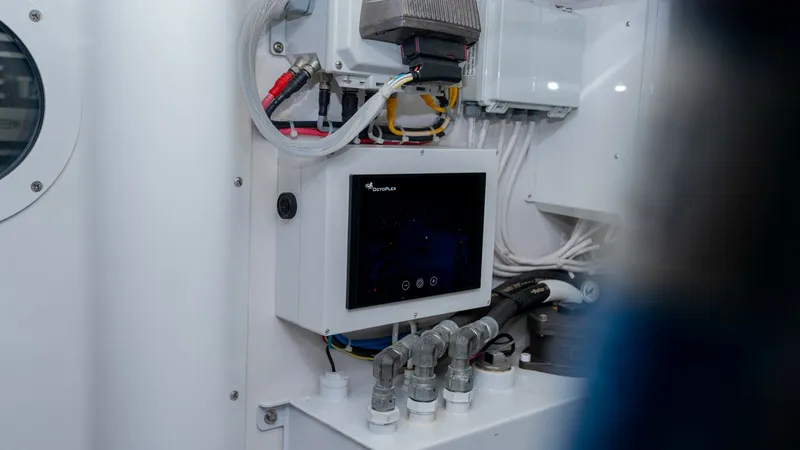 Slide: The Image of Engine Room Control Panel This image showcases the advanced control panel within the engine room of the 2019 Viking 68 Enclosed Bridge. Featuring state-of-the-art technology, the panel is designed for efficient monitoring and management of the vessel's systems. The clean layout an - 8738074