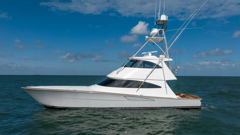Slide: The Image of Side Profile of Viking 68 Enclosed Bridge The image showcases the sleek side profile of the 2019 Viking 68 Enclosed Bridge, highlighting its streamlined design and sophisticated silhouette. The vessel's enclosed bridge provides enhanced comfort and protection, making it ideal for long journeys. I - 8738088