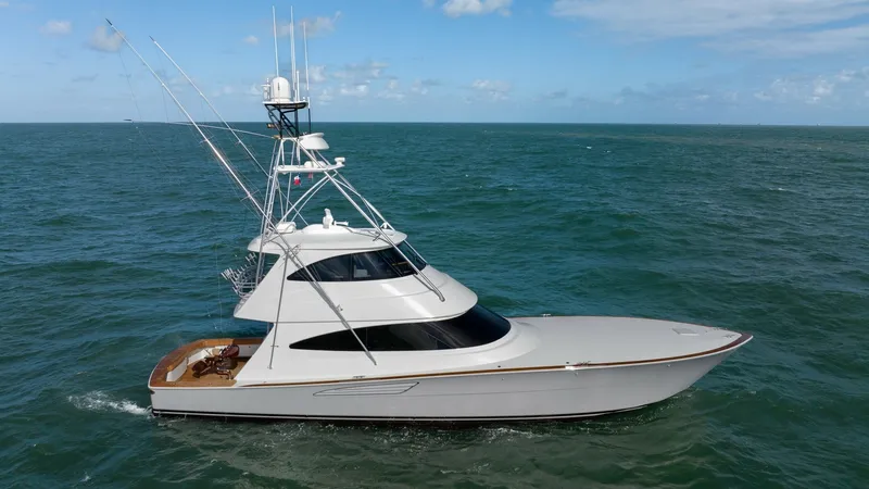 Slide: The Image of Profile View of Viking 68 Enclosed Bridge This image showcases the sleek profile of the 2019 Viking 68 Enclosed Bridge, highlighting its elegant lines and robust construction. The enclosed bridge design offers superior visibility and protection from the elements, enhancing the overall comfort for - 8738096