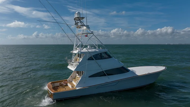 Slide: The Image of Starboard Aerial View of Viking 68 This image captures the starboard side of the 2019 Viking 68 Enclosed Bridge, named Sandman, as it navigates through open waters. The sleek design and robust structure of the enclosed bridge are complemented by the spacious aft deck, ideal for fishing or - 8738090