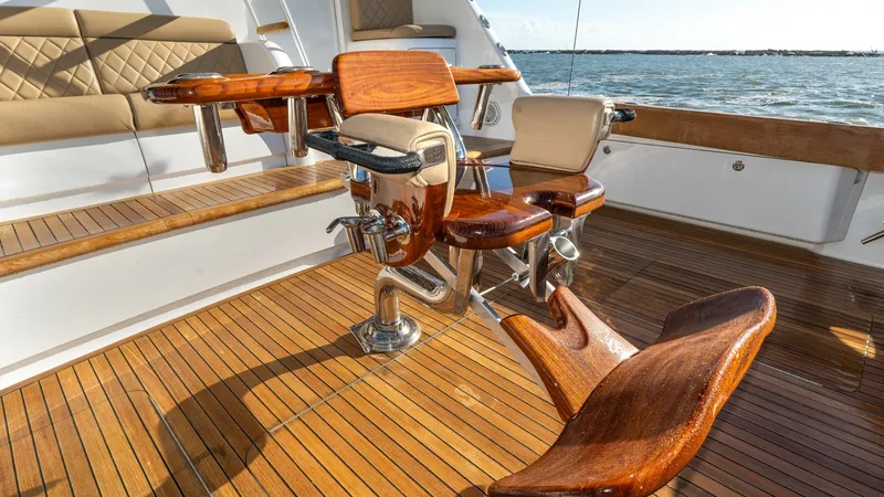 Slide: The Image of Cockpit with Fighting Chair The cockpit of the Viking 68 Enclosed Bridge features a beautifully crafted fighting chair, ideal for serious anglers. The teak decking adds a touch of elegance and durability, providing a sophisticated backdrop for fishing adventures. Ample seating and s - 8738052