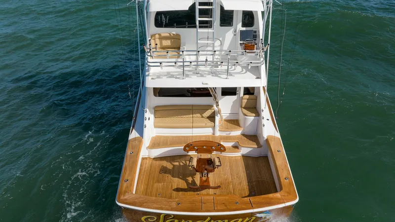 Slide: The Image of Aft Deck with Fishing Cockpit The aft deck of the 2019 Viking 68 Enclosed Bridge features a spacious fishing cockpit, complete with a custom fighting chair and teak decking for durability and style. Ample seating and storage areas are designed for comfort and functionality, making it - 8738094