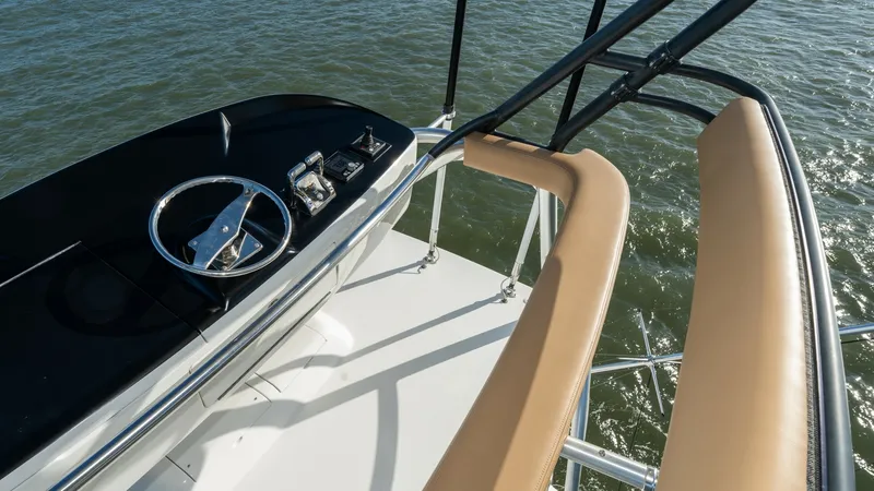 Slide: The Image of Flybridge Helm Station View The flybridge helm station of the 2019 Viking 68 Enclosed Bridge offers a commanding view over the water. Featuring a sleek, modern steering wheel and state-of-the-art navigation instruments, this space is designed for optimal control and precision. The c - 8738064