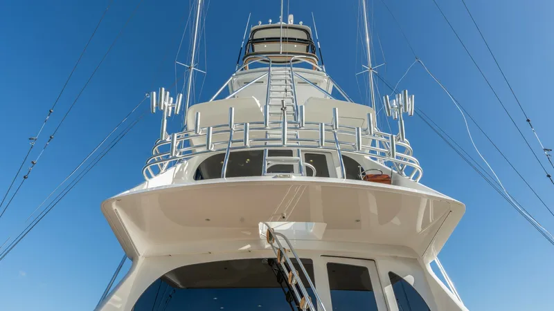 Slide: The Image of Tower and Enclosed Bridge View This image showcases the impressive tower and enclosed bridge of the 2019 Viking 68 Enclosed Bridge. The sleek lines and robust structure are accentuated by the clear blue sky, highlighting the vessel's superior craftsmanship. The enclosed bridge offers e - 8738055