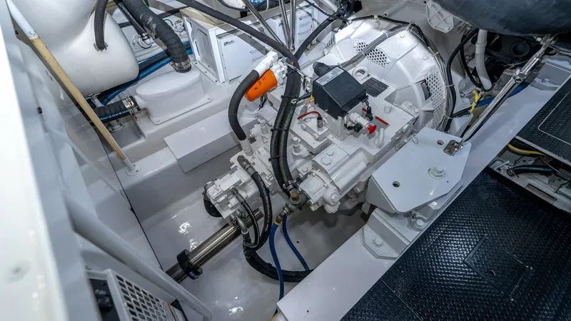 Slide: The Image of Engine Room with Transmission View This image showcases the meticulously organized engine room of the 2019 Viking 68 Enclosed Bridge, featuring a robust transmission system. The layout highlights the precision engineering and clean installation, ensuring optimal performance and reliability - 8738083