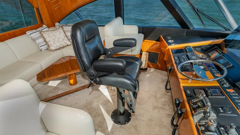 Slide: The Image of Enclosed Bridge Helm Station The helm station of the 2019 Viking 68 Enclosed Bridge offers a commanding view with its expansive windows. Featuring a plush captain's chair and state-of-the-art navigation controls, this space combines luxury and functionality. The surrounding seating a - 8738025