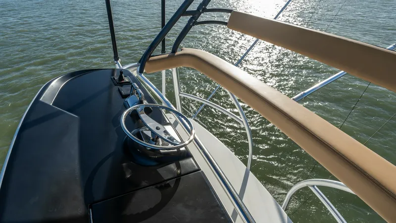 Slide: The Image of Flybridge Helm Station This image showcases the sleek helm station on the flybridge of the 2019 Viking 68 Enclosed Bridge. The polished steering wheel and advanced instrumentation provide a commanding view for easy navigation. The ergonomic layout and quality materials ensure a - 8738063