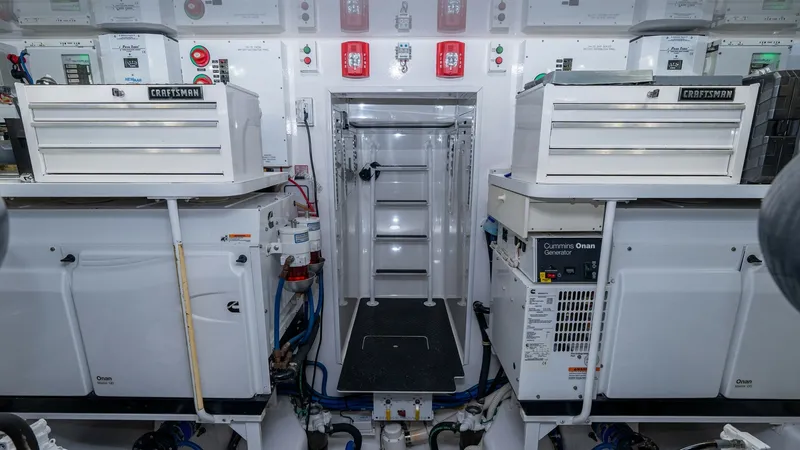 Slide: The Image of Engine Room with Advanced Systems This image showcases the meticulously organized engine room of the 2019 Viking 68 Enclosed Bridge. The space features advanced systems and equipment neatly arranged for optimal functionality and maintenance. The clean layout and high-quality components, i - 8738077