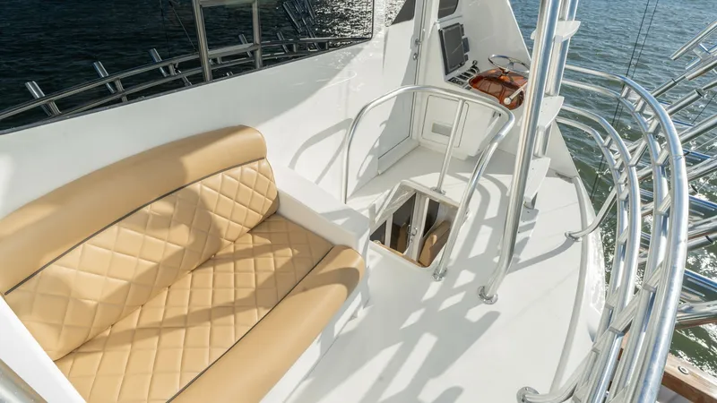Slide: The Image of Flybridge Seating Area The flybridge of the 2019 Viking 68 Enclosed Bridge offers a spacious seating area with elegant tan quilted upholstery. The design ensures comfort while providing an excellent view of the surroundings, enhanced by the polished stainless-steel handrails. T - 8738061
