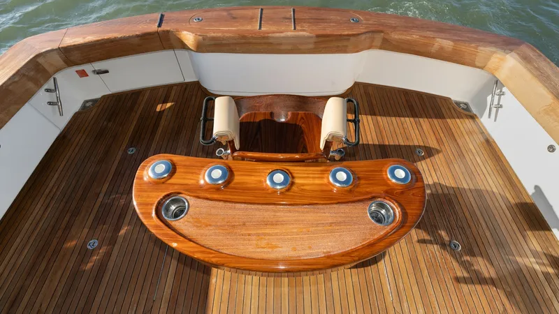Slide: The Image of Teak Cockpit with Fishing Station This image showcases the exquisite teak cockpit of the Viking 68 Enclosed Bridge, featuring a state-of-the-art fishing station. The beautifully crafted, polished woodwork and ergonomic design provide both functionality and elegance for avid anglers. Ample - 8738060