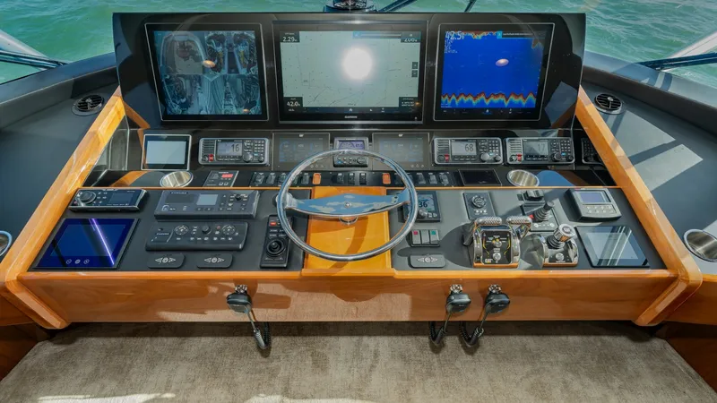 Slide: The Image of Command Bridge Helm Station The helm station of the Viking 68 Enclosed Bridge offers state-of-the-art navigation and control systems. Featuring multiple large display screens for comprehensive monitoring and a sleek, ergonomic design, this helm ensures precision and ease of use. The - 8738024