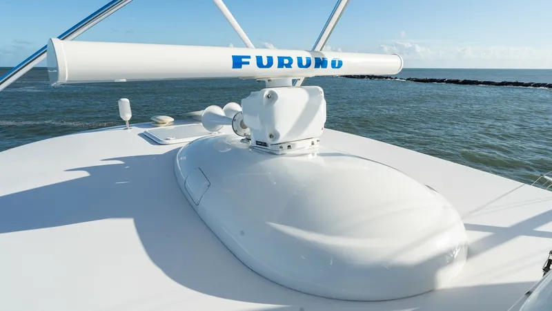 Slide: The Image of Flybridge Radar and Electronics The flybridge of the 2019 Viking 68 Enclosed Bridge showcases advanced radar and navigation systems, including a prominent Furuno unit. This setup ensures precise navigation and safety, emphasizing the yacht's commitment to cutting-edge technology. The sl - 8738062