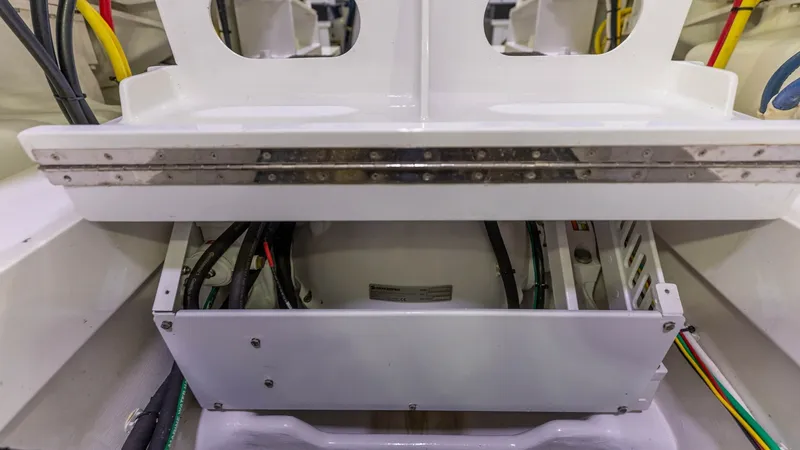 Slide: The Image of Engine Room Electrical Panel This image showcases the well-organized electrical panel within the engine room of the 2019 Viking 68 Convertible. The panel is neatly arranged with clearly labeled wiring for easy maintenance and troubleshooting. The use of high-quality materials ensures - 8679303