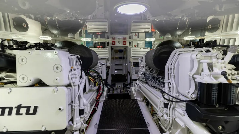 Slide: The Image of Engine Room with Twin MTU Engines The engine room of the 2019 Viking 68 Convertible 'Gas Money' showcases powerful twin MTU engines, meticulously arranged for optimal performance. The space is well-lit, highlighting the clean and organized layout, with easy access for maintenance. High-qu - 8679299