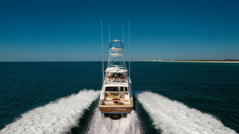 Slide: The Image of Aerial Stern View at Sea This stunning aerial shot captures the powerful presence of the 2019 Viking 68 Convertible, 'Gas Money', cutting through the ocean with ease. The image highlights the impressive wake trailing behind, showcasing the vessel's performance and speed. The spac - 8679313