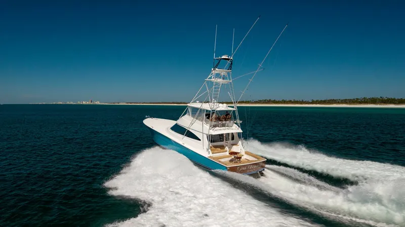 Slide: The Image of Aerial View of Viking 68 Convertible The 2019 Viking 68 Convertible, 'Gas Money,' is captured cruising powerfully through open waters. This dynamic aerial view highlights its sleek hull design and spacious aft deck, ideal for sportfishing and leisure. The vessel's tower offers excellent visi - 8679310