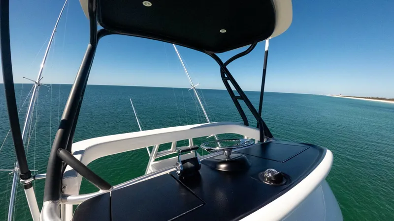 Slide: The Image of Flybridge Helm Station The flybridge helm station on the 2019 Viking 68 Convertible 'Gas Money' offers a commanding view of the open sea. Featuring a sleek black console with state-of-the-art controls, this area is designed for optimal navigation and comfort. The sturdy structu - 8679292