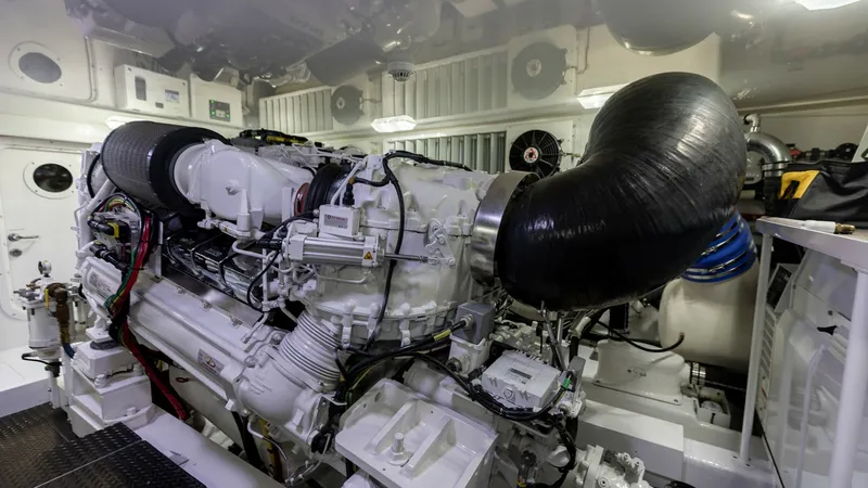 Slide: The Image of Engine Room with Twin Diesel Engines This image showcases the meticulously maintained engine room of the 2019 Viking 68 Convertible, featuring powerful twin diesel engines. The space is well-organized, with a clean layout that allows for easy access and maintenance. High-quality components a - 8679301