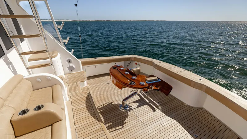Slide: The Image of Spacious Aft Deck with Fishing Chair The aft deck of the 2019 Viking 68 Convertible features a luxurious teak finish, offering a perfect blend of elegance and functionality. Prominently equipped with a high-quality fighting chair, this space is ideal for avid anglers. The comfortable seating - 8679295