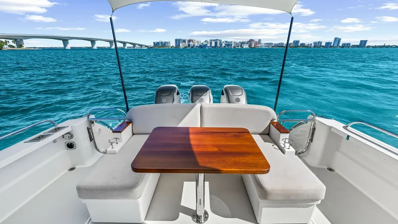 Slide: The Image of Aft Deck with Seating and Table This inviting aft deck of the 2022 Back Cove 390 features a comfortable seating area with plush cushions and a sleek wooden table, perfect for alfresco dining. The spacious layout offers easy access to the water, enhanced by the panoramic views of the sur - 8738147