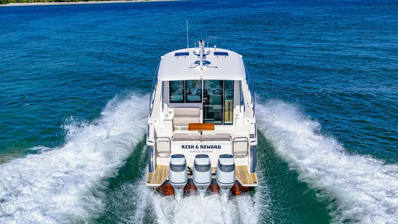Slide: The Image of Aft View with Quad Engines This striking aft view of the Back Cove 390 showcases its powerful quad outboard engines, ensuring impressive speed and performance. The spacious swim platform provides easy access to the water, while the clean lines of the hull emphasize its modern desig - 8738173