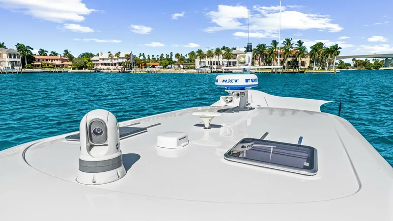Slide: The Image of Bow Deck with Navigation Equipment The bow deck of the 2022 Back Cove 390 'Risk and Reward' showcases modern navigation equipment, including a radar and camera system. The sleek, clean lines of the deck are complemented by solar panels, enhancing both functionality and sustainability. The - 8738158