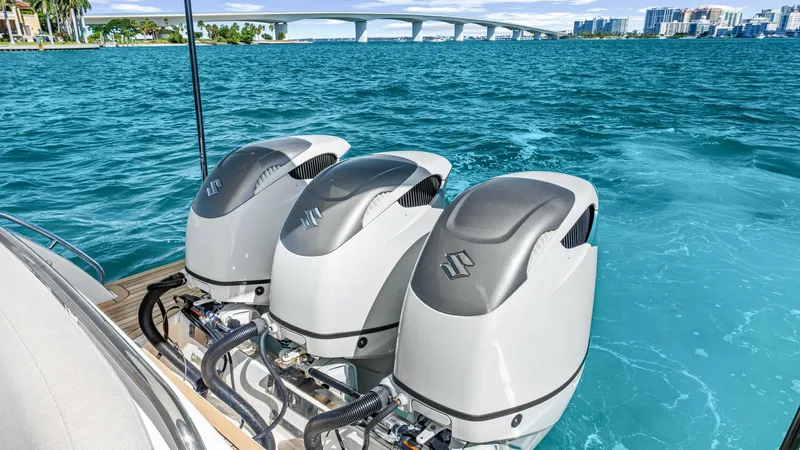 Slide: The Image of Triple Outboard Motors on Swim Platform This image showcases the powerful triple outboard motors on the Back Cove 390, offering exceptional performance and reliability. The sleek design of the motors complements the vessel's modern aesthetic, while the spacious swim platform provides easy acces - 8738151