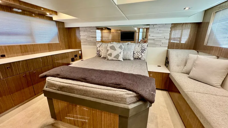 Slide: The Image of Luxurious Master Stateroom Interior The master stateroom of the 2024 Cruisers Yachts 50 Cantius showcases a perfect blend of elegance and comfort. It features a spacious queen-sized bed with plush bedding, surrounded by rich wood finishes and ample storage solutions. Large windows and reces - 8737993