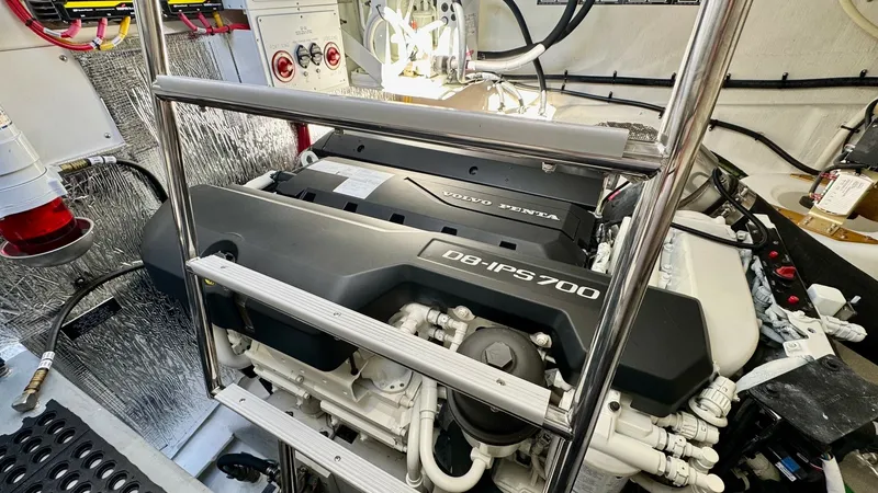 Slide: The Image of Engine Room with Volvo Penta IPS700 This image showcases the well-organized engine room of the 2024 Cruisers Yachts 50 Cantius, featuring the powerful Volvo Penta D8-IPS700 engine. The space is meticulously arranged, providing easy access for maintenance and operation. The environment is cl - 8737998