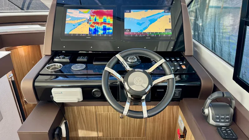 Slide: The Image of Helm Station with Dual Displays The helm station of the 2024 Cruisers Yachts 50 Cantius features dual high-resolution displays, providing essential navigation and system information at a glance. The sleek steering wheel is complemented by ergonomic controls, ensuring a comfortable and e - 8737981