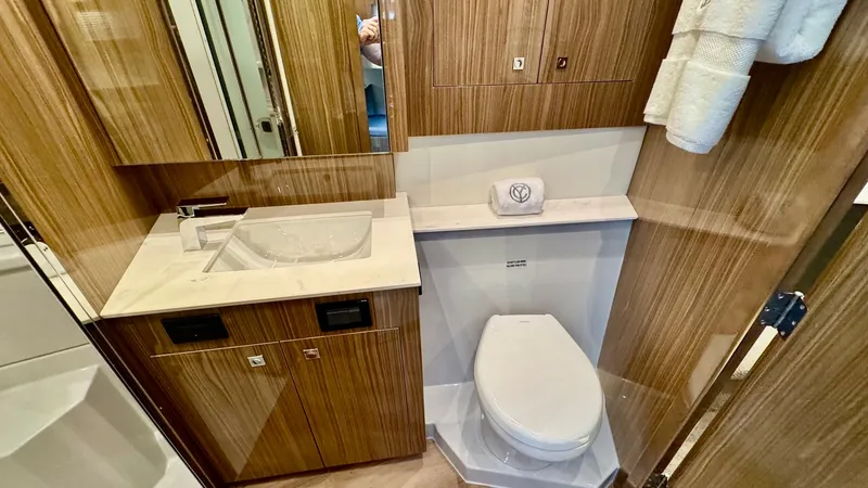 Slide: The Image of Luxurious Ensuite Bathroom The ensuite bathroom of the 2024 Cruisers Yachts 50 Cantius features elegant wood cabinetry and a sleek marble countertop, offering a modern and sophisticated design. A contemporary sink and high-end fixtures complement the space, while the cleverly integ - 8737994