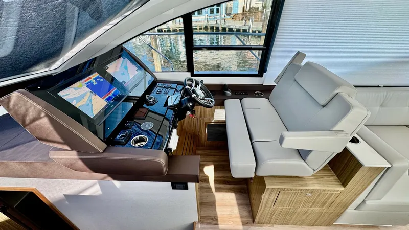 Slide: The Image of Helm Station with Dual Seating The helm station of the 2024 Cruisers Yachts 50 Cantius features a sleek, modern dashboard with advanced navigation displays. The dual seating offers plush comfort and ergonomic design, perfect for long voyages. Large windows provide excellent visibility - 8737987
