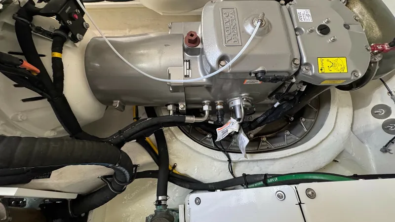 Slide: The Image of Engine Compartment Overview This image showcases the meticulously organized engine compartment of the 2024 Cruisers Yachts 50 Cantius. The area is designed for optimal performance and easy maintenance, featuring a well-secured engine with accessible wiring and components. The clean - 8738001