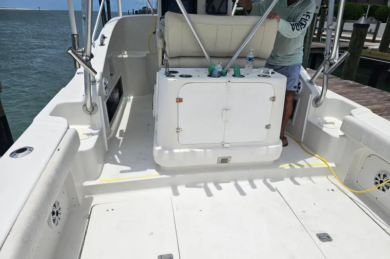 Slide: The Image of 1996 Hydrocat 300 X boat interior with seating and storage, docked by the water. - 20