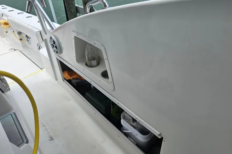 Slide: The Image of Interior view of a 1996 Hydrocat 300 X boat, featuring storage compartments and seating area. - 18