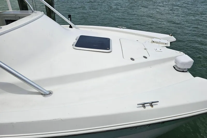 Slide: The Image of 1996 Hydrocat 300 X boat deck with hatch, docked on calm water. - 25