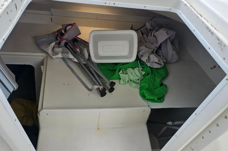 Slide: The Image of Interior of a 1996 Hydrocat 300 X boat with gear and cooler. - 15