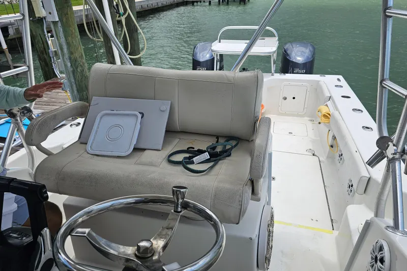 Slide: The Image of Interior of a 1996 Hydrocat 300 X boat with seating and dual outboard motors. - 19