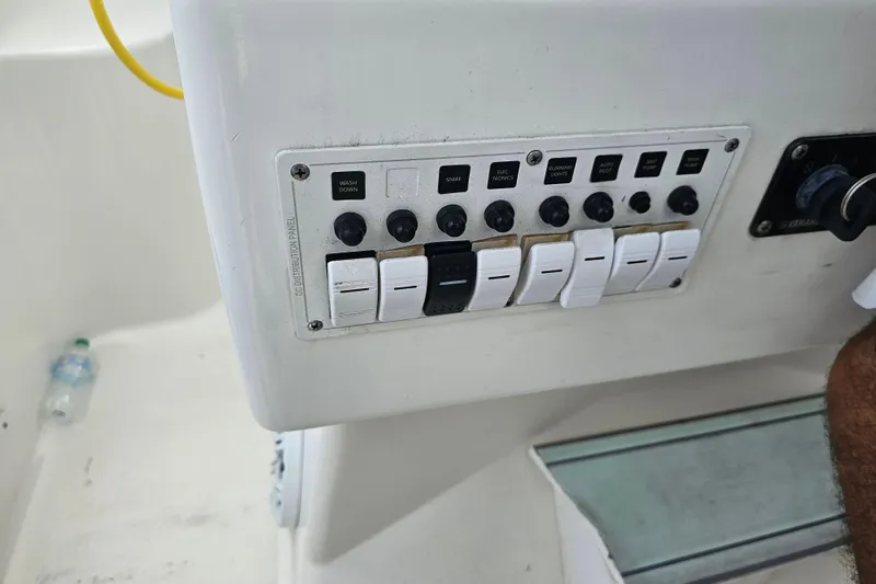Slide: The Image of Control panel of a 1996 Hydrocat 300 X boat with labeled switches and key ignition. - 14