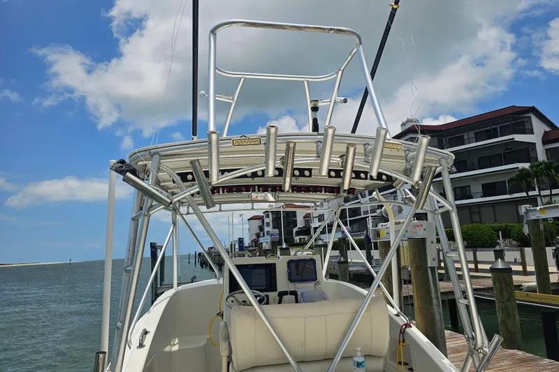 Slide: The Image of 1996 Hydrocat 300 X boat docked, featuring a sturdy metal frame and clear blue sky. - 21