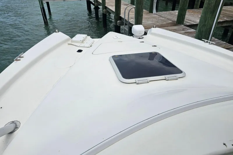 Slide: The Image of Bow of a 1996 Hydrocat 300 X boat docked by wooden piers. - 16