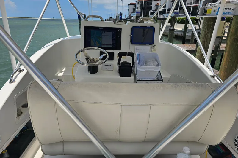 Slide: The Image of Interior view of a 1996 Hydrocat 300 X boat with steering console and navigation equipment. - 22