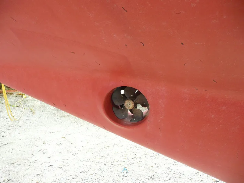 Slide: The Image of Red hull of 1991 Island Packet 38 sailboat with visible propeller. - 28