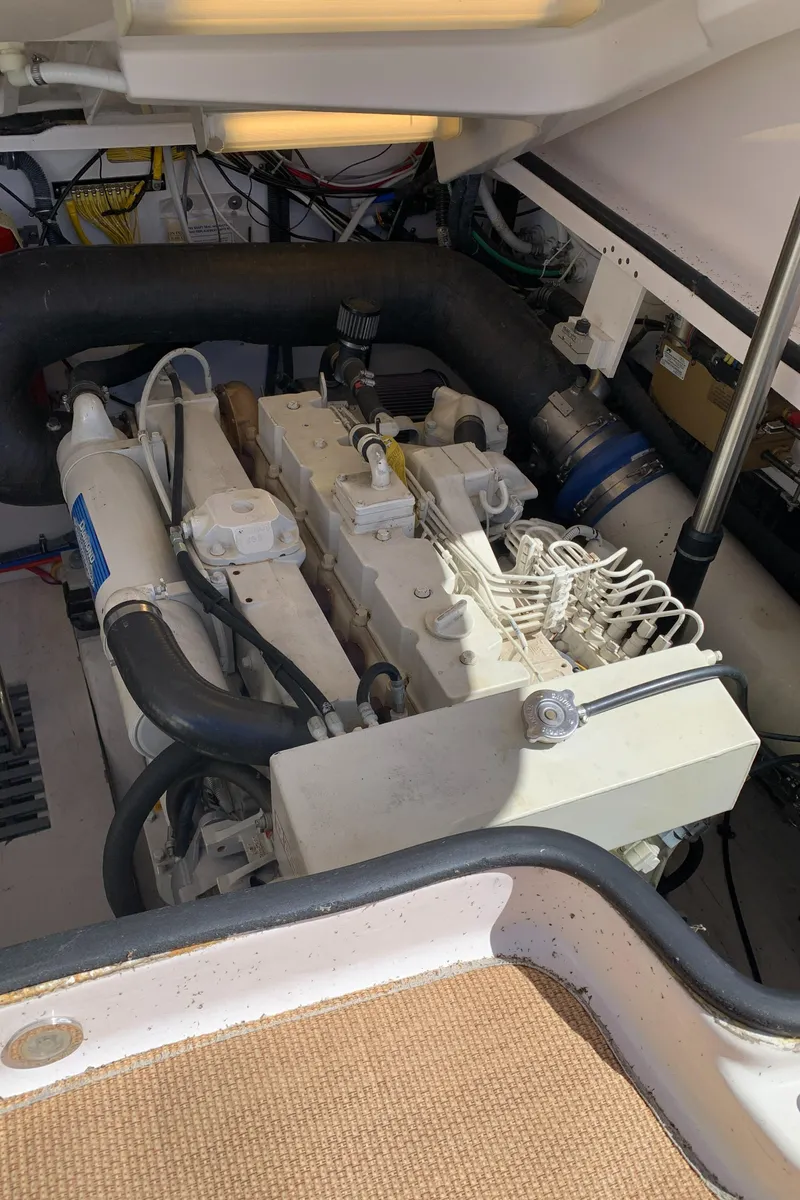 Slide: The Image of Engine compartment of 2004 Tiara Yachts 3600 Sovran, showcasing mechanical components and wiring. - 48