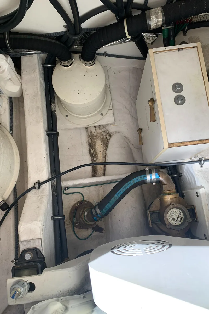 Slide: The Image of Engine compartment of a 2004 Tiara Yachts 3600 Sovran, showing hoses and mechanical components. - 49