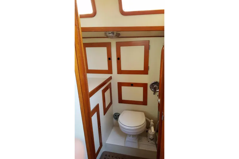 Slide: The Image of Compact bathroom in 1988 Alden 46 yacht with wooden cabinetry and marine toilet. - 15
