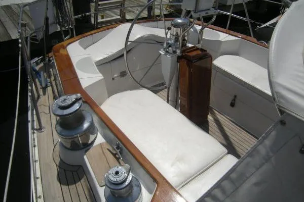 Slide: The Image of 1988 Alden 46 yacht cockpit with white seating and wooden accents. - 5