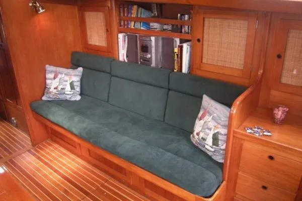 Slide: The Image of Luxurious 1988 Alden 46 yacht interior with green sofa and nautical-themed pillows. - 9
