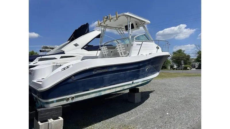 Slide: The Image of 2005 Seaswirl Striper 2301 Dual Console O/B boat on display outdoors. - 2